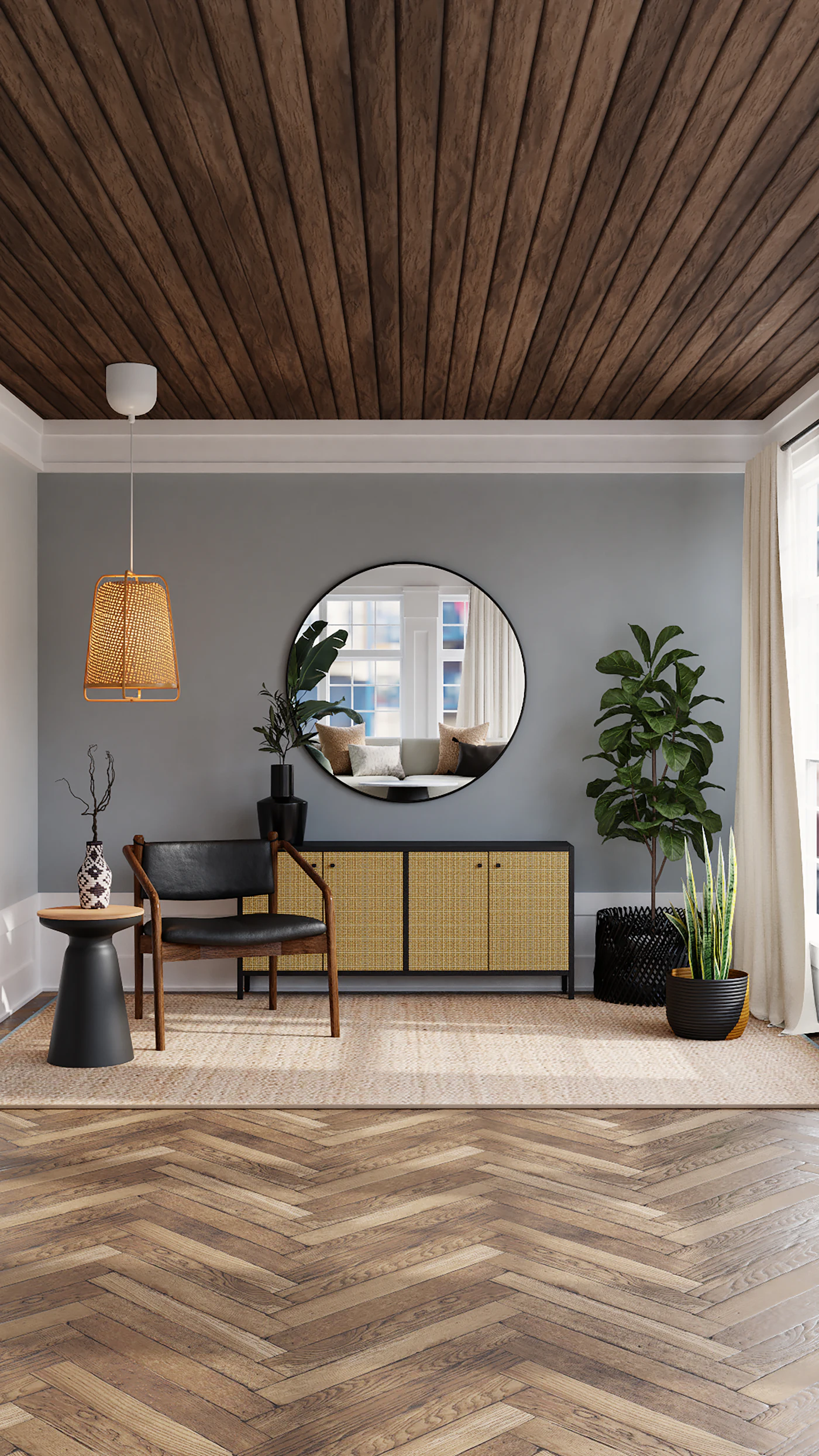 Grey-walled living space with round mirror, rattan pendant and mid-century furniture