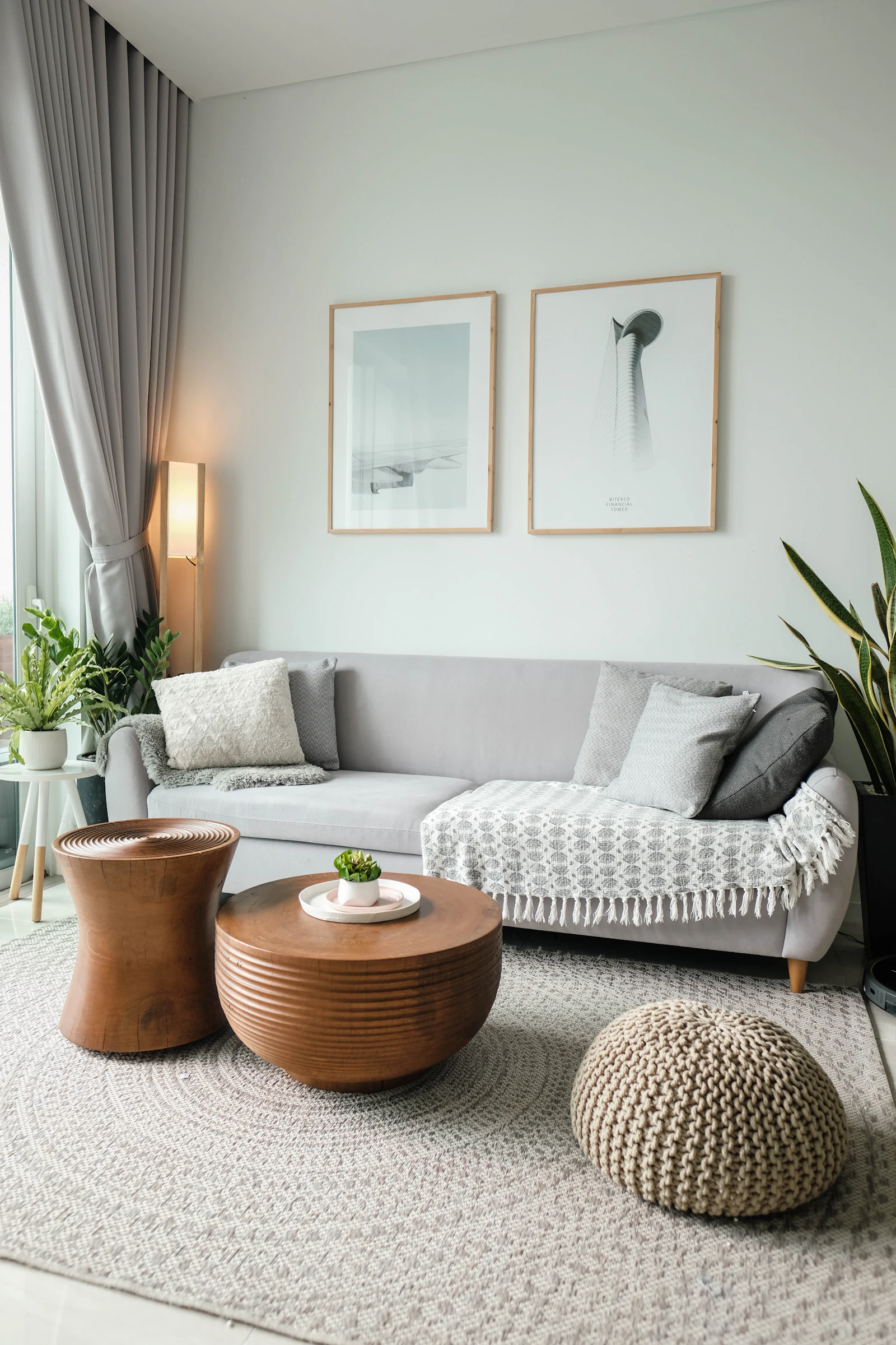 Neutral living room with grey sofa, textured throw and timber side table