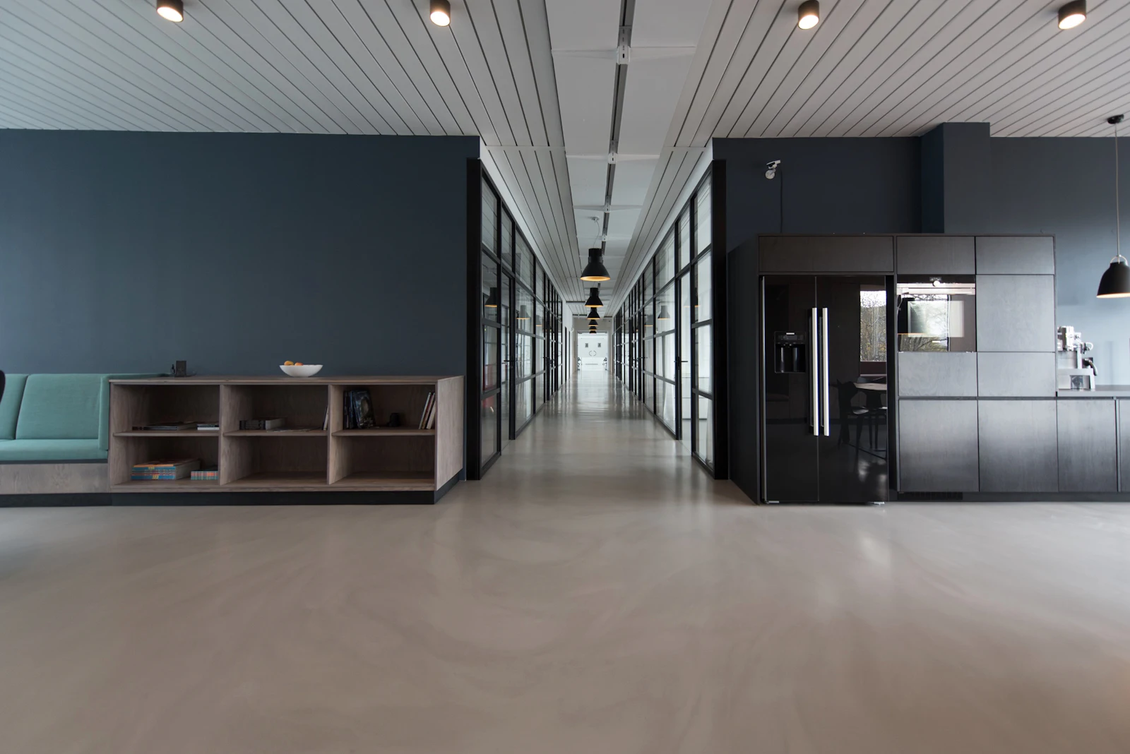 Modern office corridor with glass partitions and minimal finishes