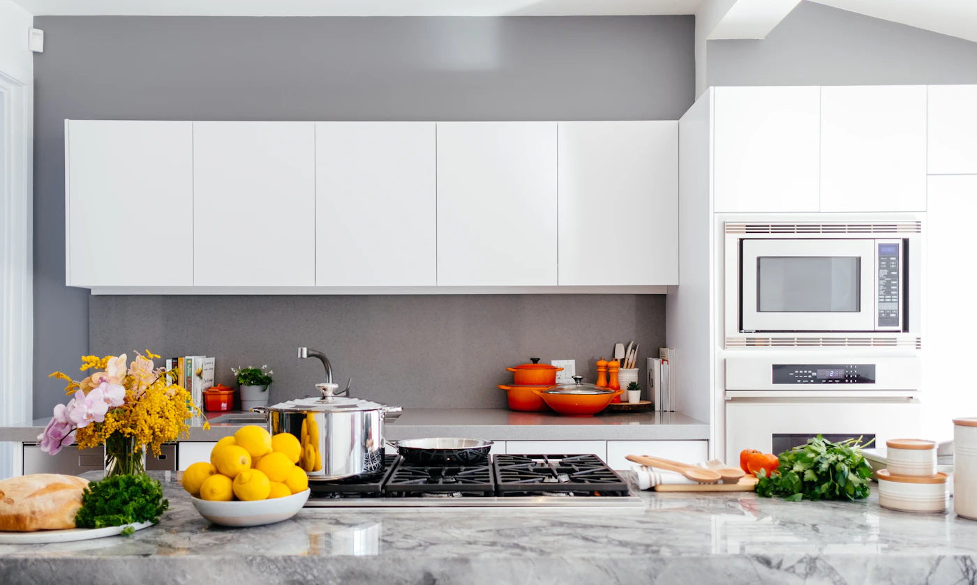 Marble-topped modular kitchen with organised storage and natural light